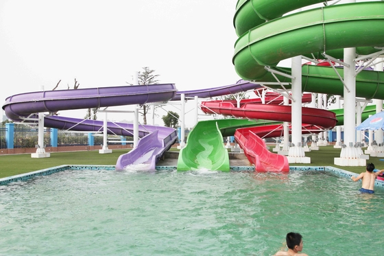 Equipamento colorido do parque do Aqua, família que transporta a corrediça de água para o grande parque da água